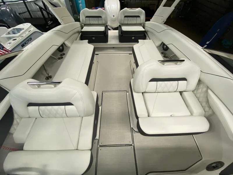 Slide: The Image of 2026 Regal LX6 boat storage compartment with open hatch and hydraulic supports. - 8