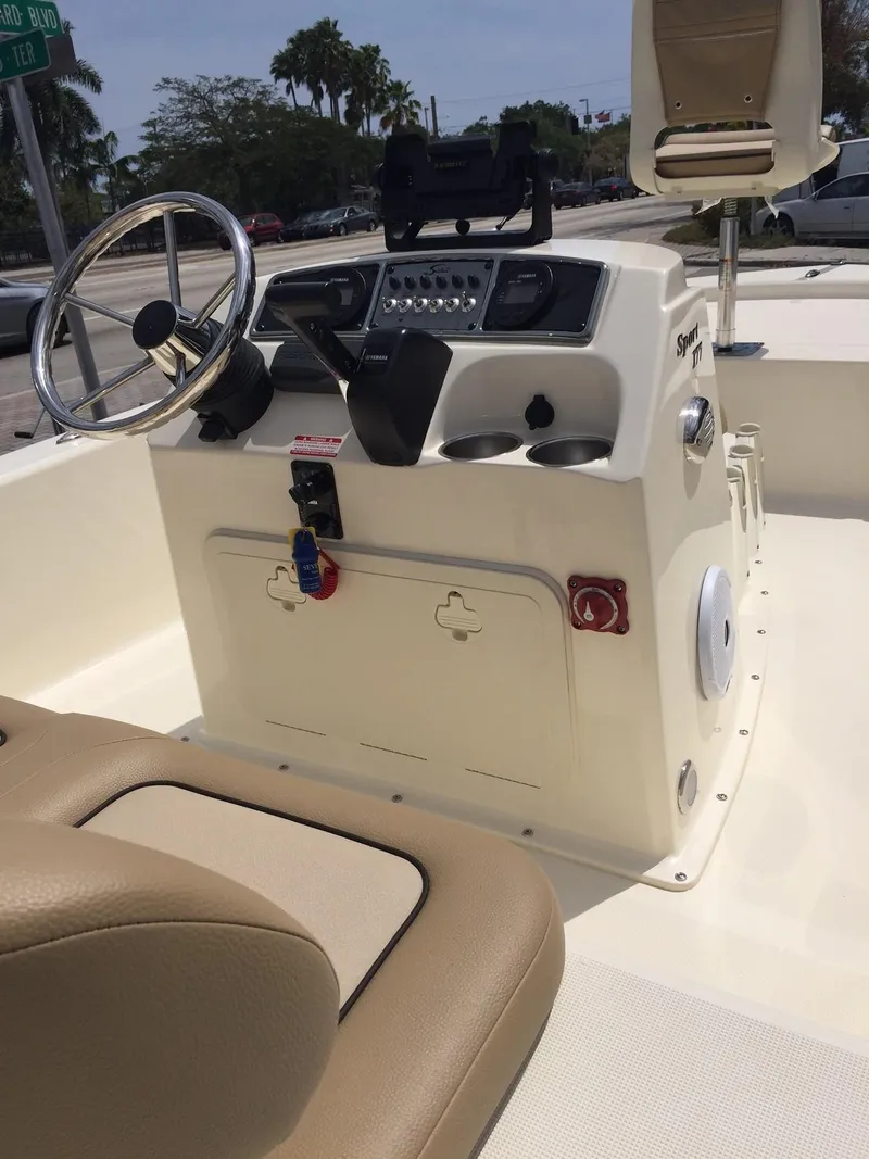 Slide: The Image of 2025 Scout 177 Sport boat console with steering wheel and controls. - 1