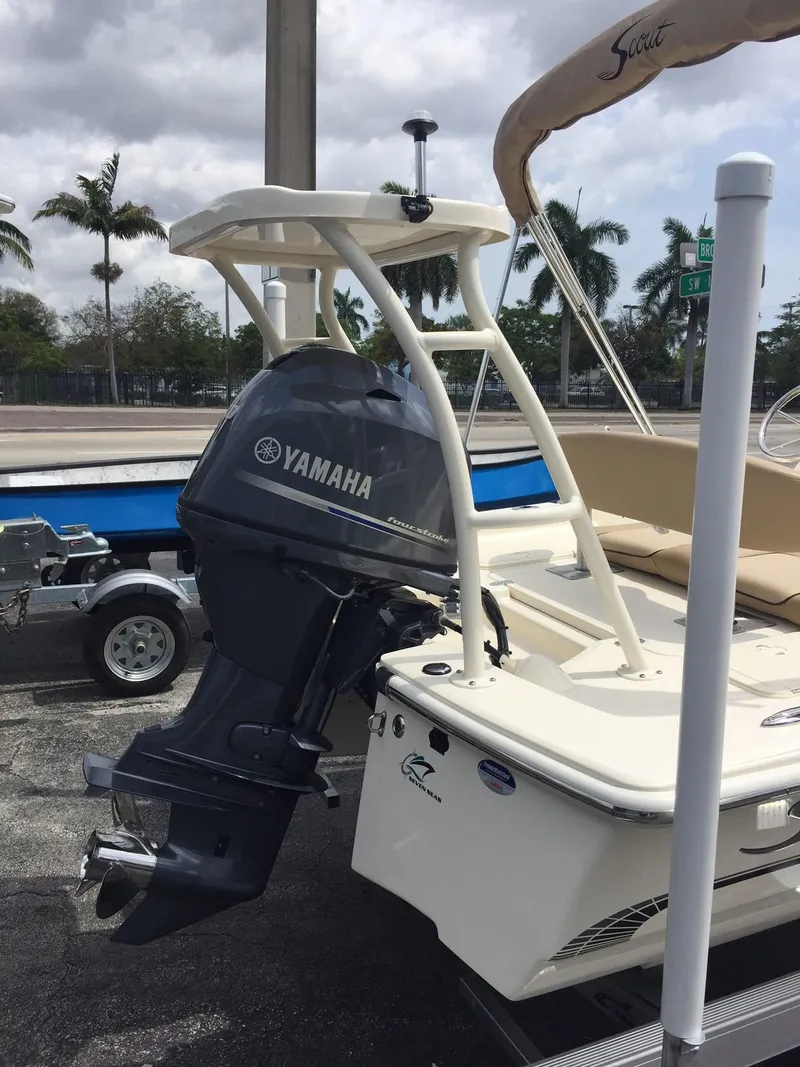 Slide: The Image of 2025 Scout 177 Sport boat with Yamaha outboard motor in a parking lot. - 2
