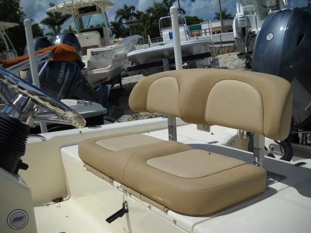 Slide: The Image of 2025 Scout 177 Sport boat with beige seating and steering wheel. - 3