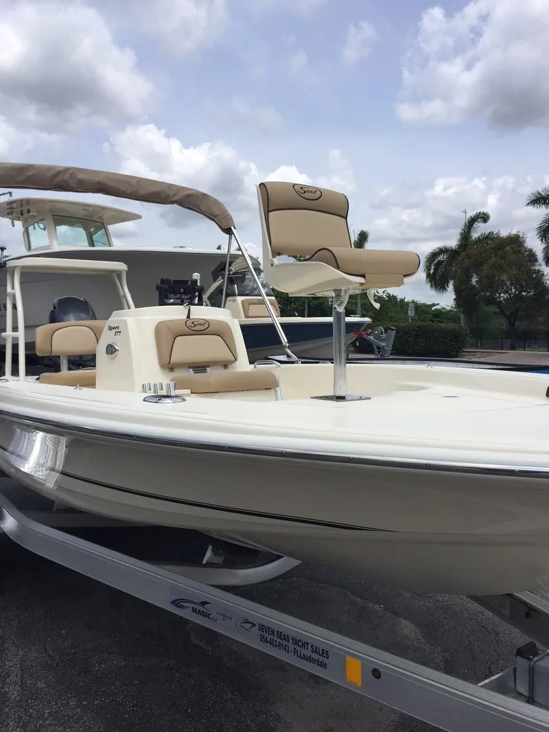 Slide: The Image of 2025 Scout 177 Sport boat on trailer with beige seating and canopy. - 4