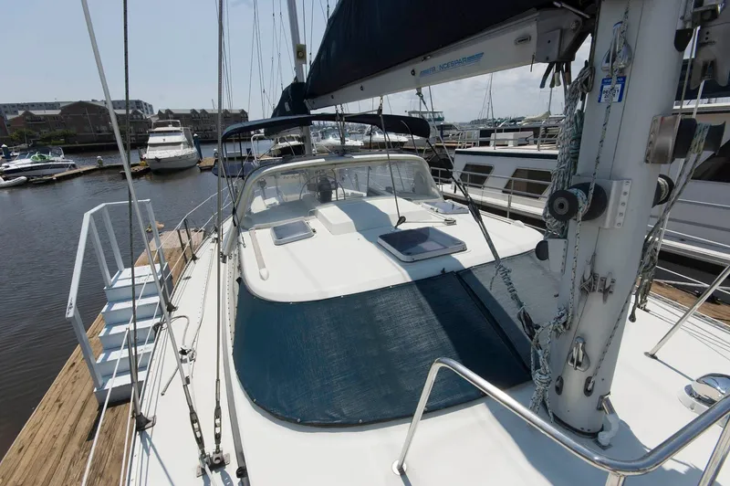 Slide: The Image of 1984 Jouet 1280 sailboat docked at a marina, surrounded by other boats. - 13