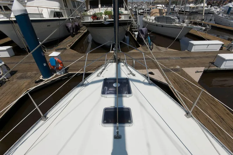 Slide: The Image of Bow view of 1984 Jouet 1280 sailboat docked at marina. - 14