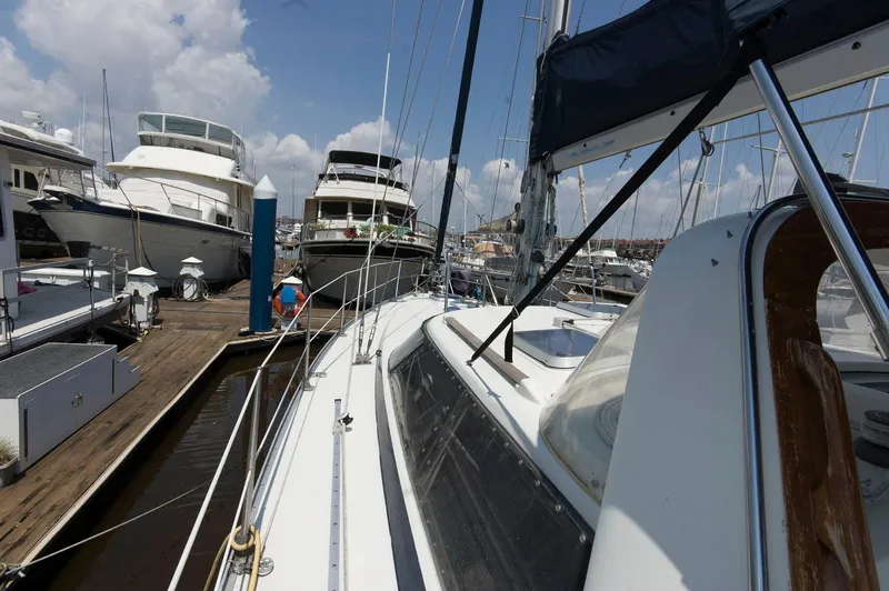 Slide: The Image of 1984 Jouet 1280 sailboat docked at a marina with other yachts. - 16