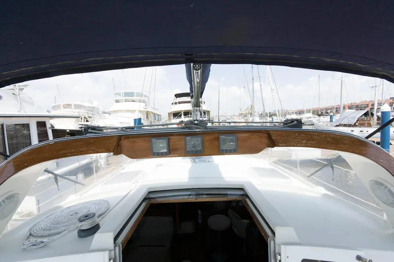 Slide: The Image of Cockpit view of a 1984 Jouet 1280 sailboat docked at a marina. - 17