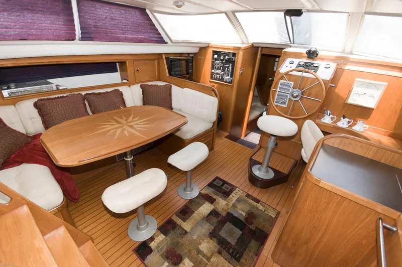 Slide: The Image of Luxurious interior of a 1984 Jouet 1280 sailboat with wooden furnishings and cozy seating. - 19