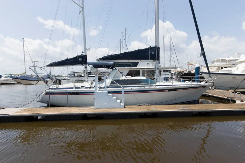 Slide: The Image of 1984 Jouet 1280 sailboat docked at marina with clear sky. - 2