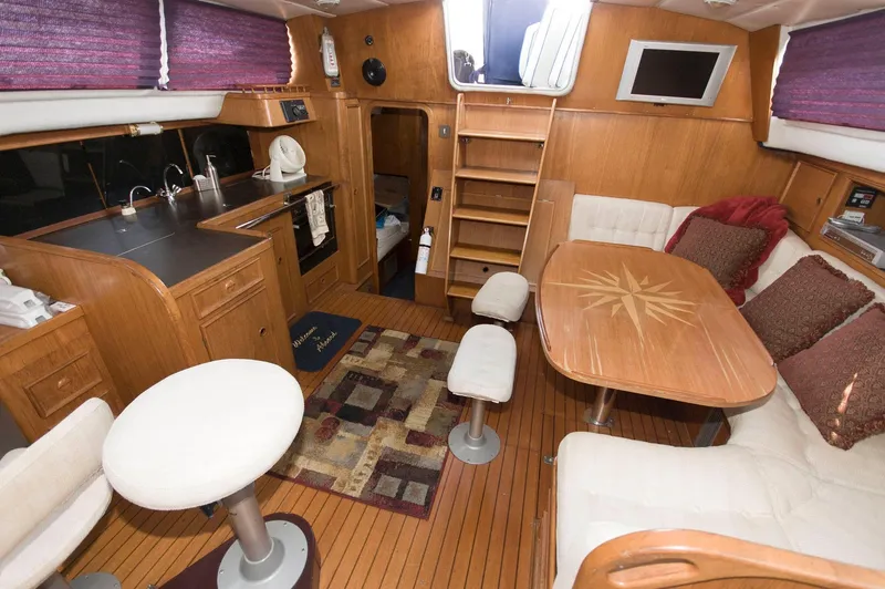Slide: The Image of Interior of 1984 Jouet 1280 sailboat with wooden furnishings and cozy seating area. - 21