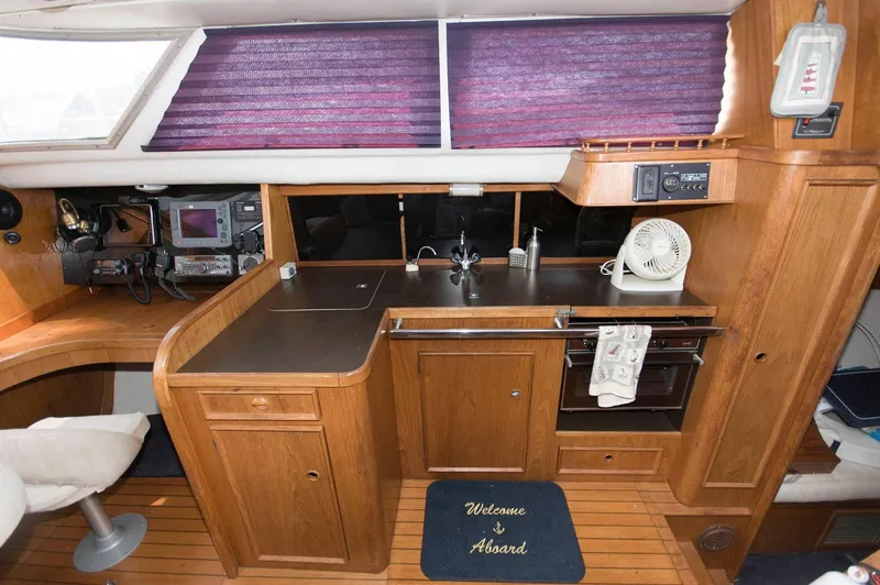 Slide: The Image of 1984 Jouet 1280 yacht interior with kitchen, wooden cabinets, and appliances. - 22