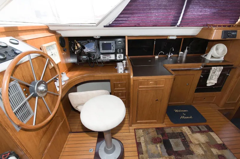 Slide: The Image of Interior of 1984 Jouet 1280 yacht with steering wheel, navigation equipment, and kitchenette. - 23