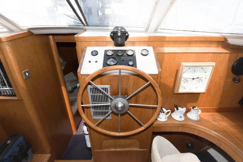 Slide: The Image of Vintage 1984 Jouet 1280 boat helm with wooden steering wheel and navigation instruments. - 24