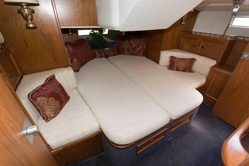 Slide: The Image of Interior cabin of a 1984 Jouet 1280 sailboat with cozy bedding and wooden furnishings. - 27