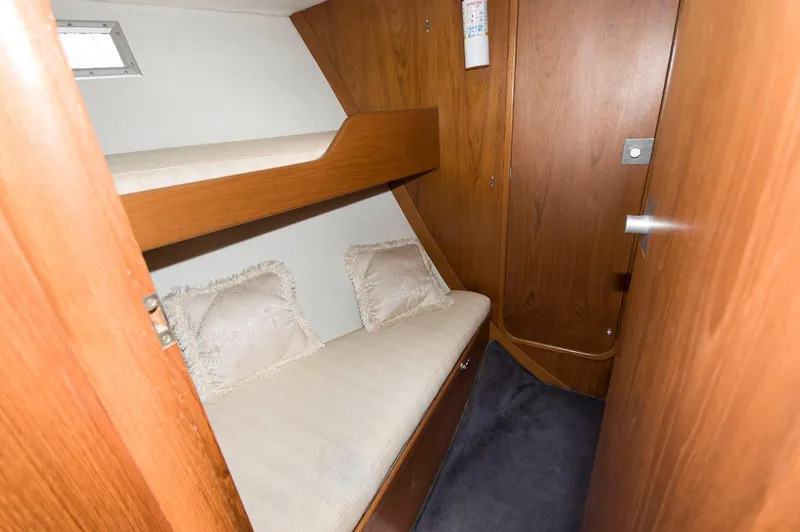 Slide: The Image of Cozy cabin with wooden bunk beds in a 1984 Jouet 1280 sailboat. - 30