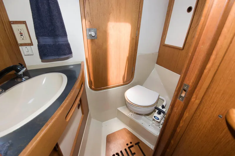 Slide: The Image of 1984 Jouet 1280 boat bathroom with sink, toilet, and wooden accents. - 31