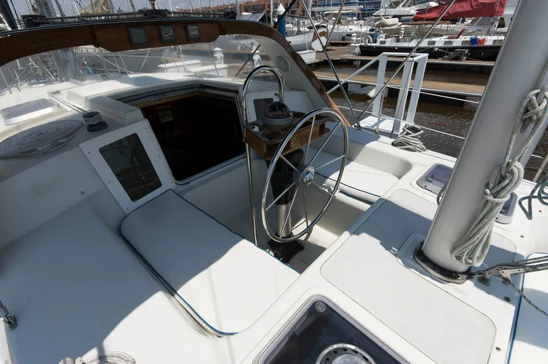 Slide: The Image of Cockpit of a 1984 Jouet 1280 sailboat with steering wheel and navigation instruments. - 8