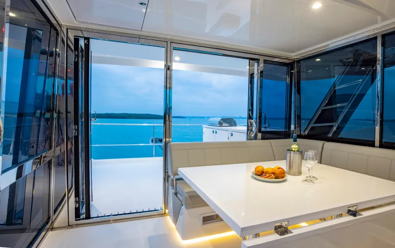 Slide: The Image of Interior of 2023 Aquila 54 Yacht with ocean view and dining area. - 15