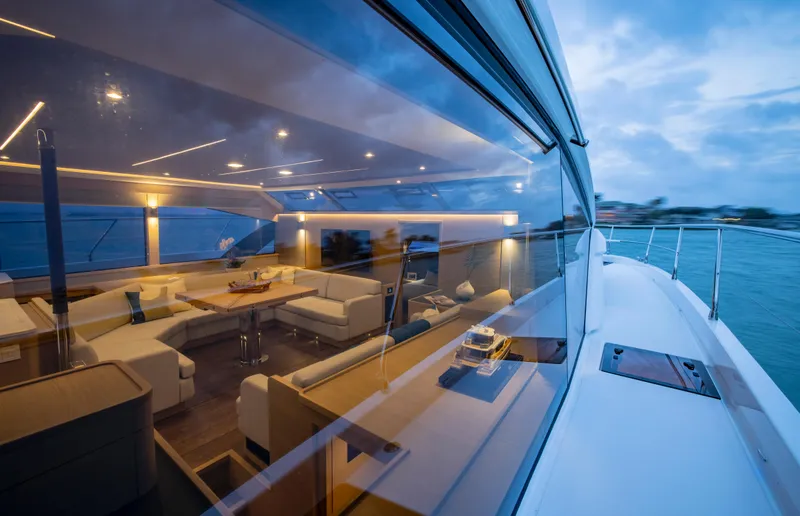 Slide: The Image of Aquila 54 Yacht 2023 model, luxurious interior view through window at sunset. - 17