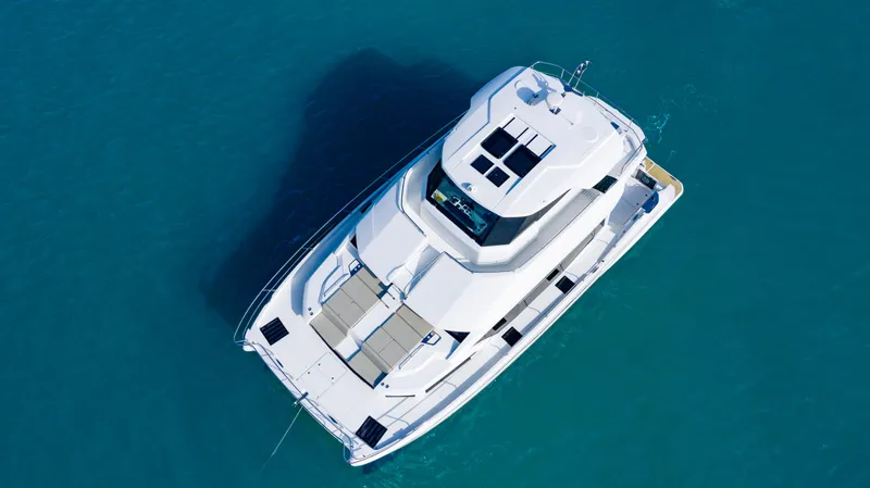 Slide: The Image of Aerial view of 2023 Aquila 54 Yacht cruising on clear blue water. - 5