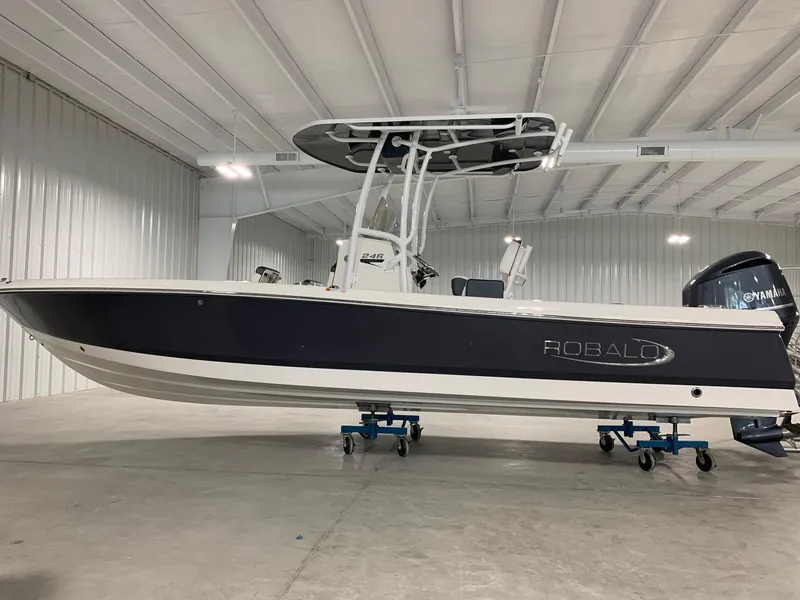 The Image of 2024 Robalo 246 Cayman boat in a spacious indoor storage facility. - 0
