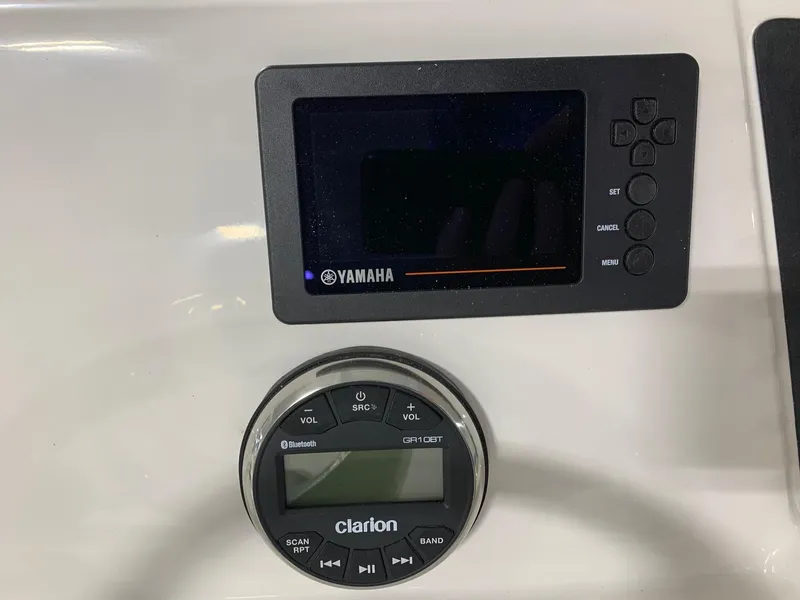 Slide: The Image of Yamaha and Clarion control panels on 2024 Robalo 246 Cayman boat. - 11