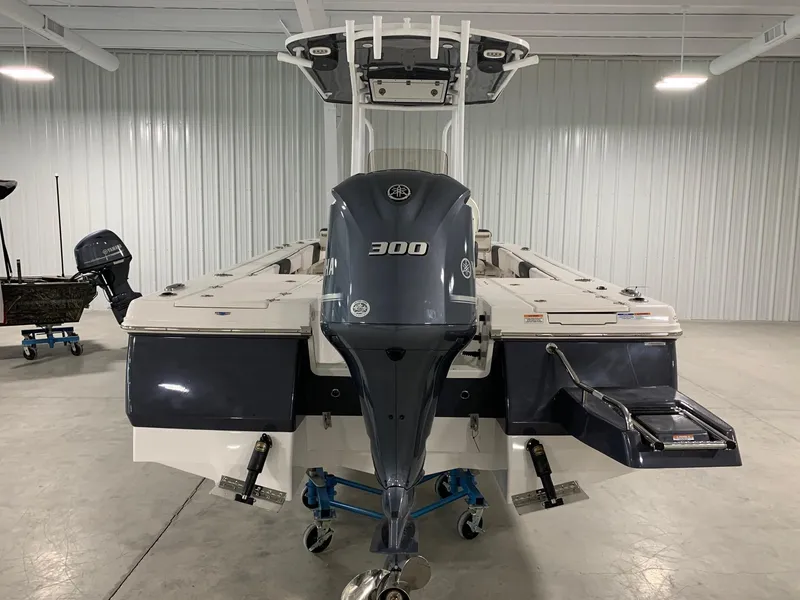 Slide: The Image of 2024 Robalo 246 Cayman boat with 300 HP engine in a showroom. - 2