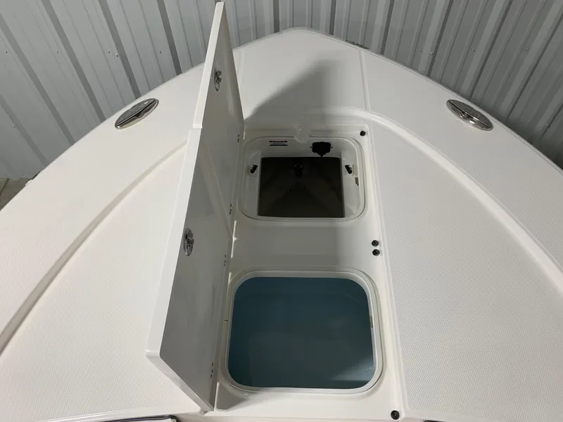 Slide: The Image of 2024 Robalo 246 Cayman boat storage compartments with open hatches. - 21