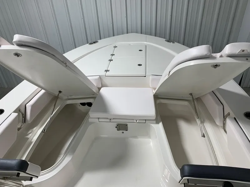 Slide: The Image of 2024 Robalo 246 Cayman boat with open storage compartments. - 25