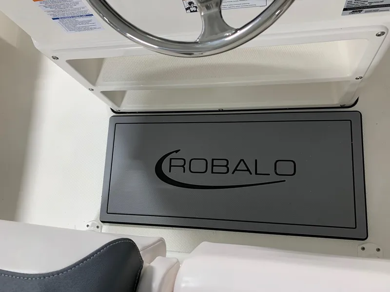 Slide: The Image of 2024 Robalo 246 Cayman boat interior with branded floor mat. - 27