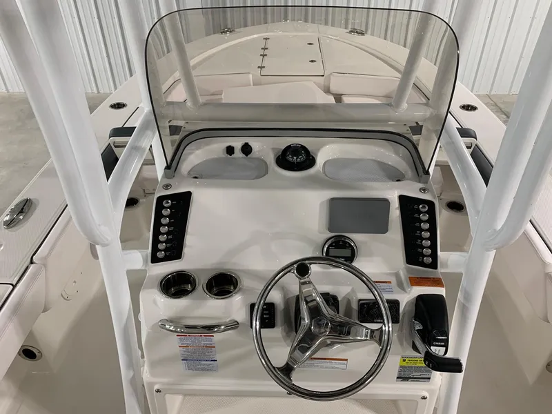 Slide: The Image of 2024 Robalo 246 Cayman boat console with steering wheel and controls. - 5