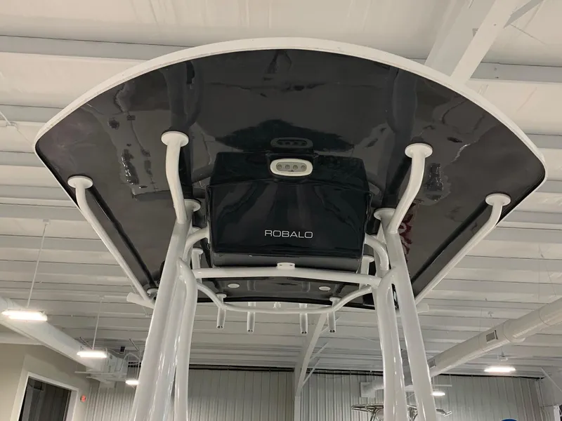 Slide: The Image of 2024 Robalo 246 Cayman T-top view in indoor showroom. - 7