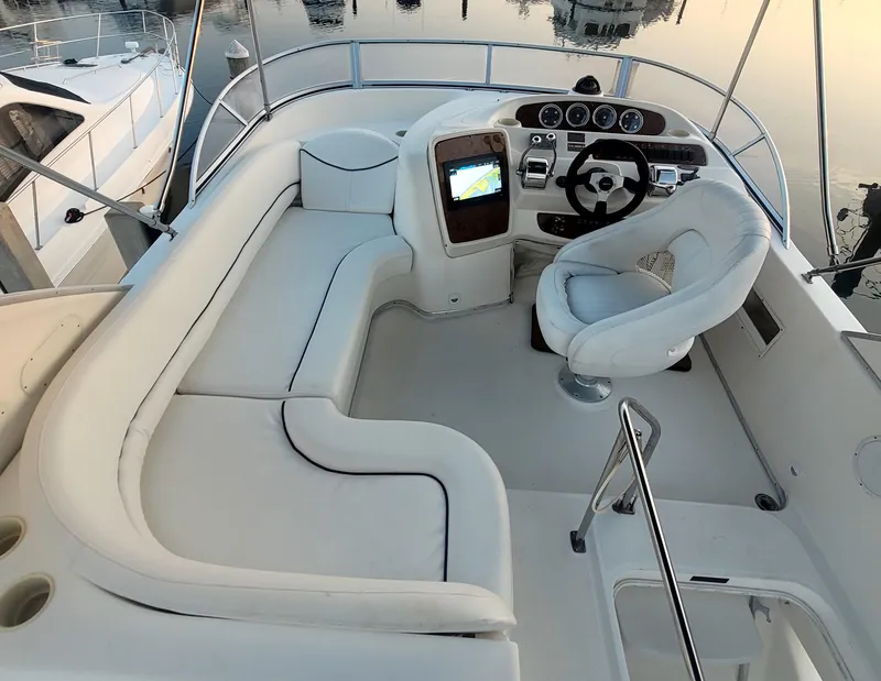 Slide: The Image of 2004 Meridian 341 Sedan boat cockpit with white seating and modern controls. - 12