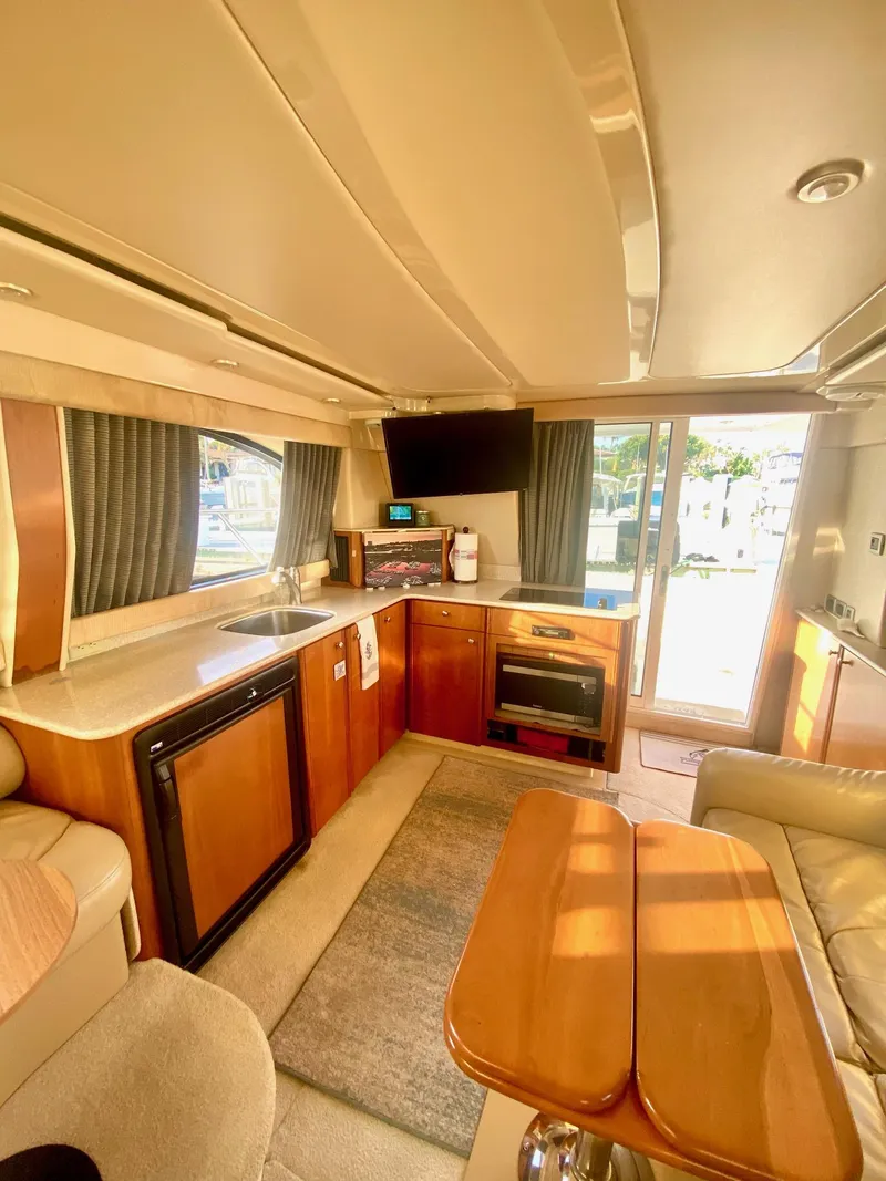 Slide: The Image of Luxurious interior of a 2004 Meridian 341 Sedan yacht with modern kitchen amenities. - 16