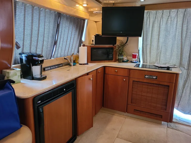 Slide: The Image of Interior of 2004 Meridian 341 Sedan yacht kitchen with appliances and wooden cabinetry. - 17