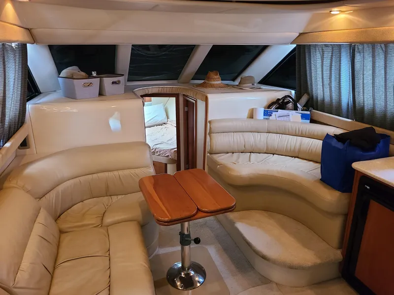 Slide: The Image of Interior of 2004 Meridian 341 Sedan yacht with beige leather seating and wooden table. - 18