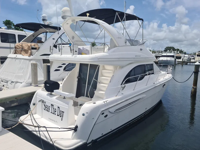 Slide: The Image of 2004 Meridian 341 Sedan yacht docked at marina, "Seas The Day" on stern. - 2