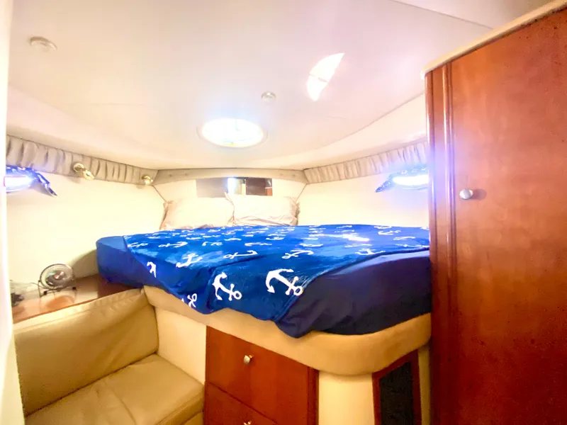 Slide: The Image of Cozy cabin interior of 2004 Meridian 341 Sedan with nautical-themed bedding. - 20