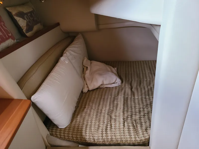 Slide: The Image of Cozy cabin interior of 2004 Meridian 341 Sedan with bed and pillows. - 25