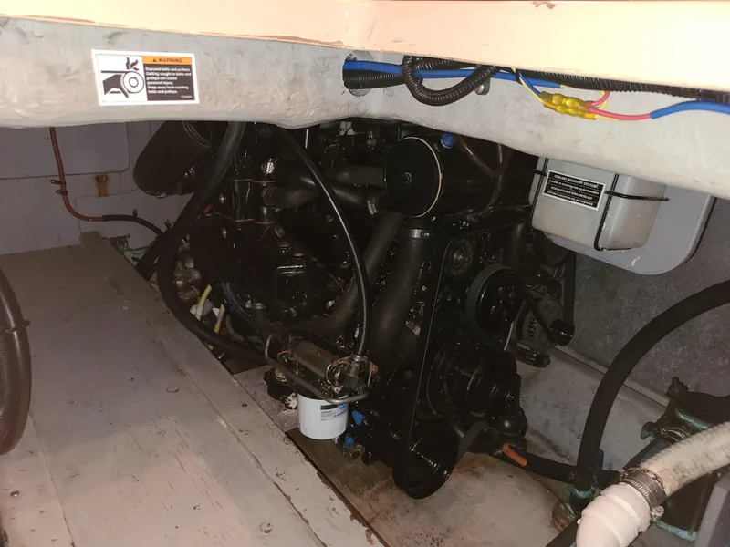 Slide: The Image of Engine compartment of a 2004 Meridian 341 Sedan boat, showcasing mechanical components and wiring. - 27