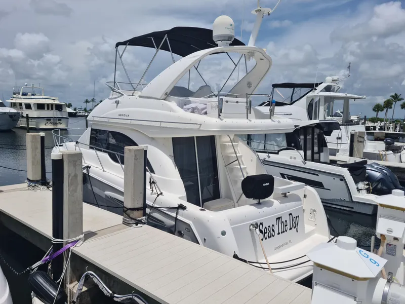 Slide: The Image of 2004 Meridian 341 Sedan yacht docked at marina under cloudy sky. - 3