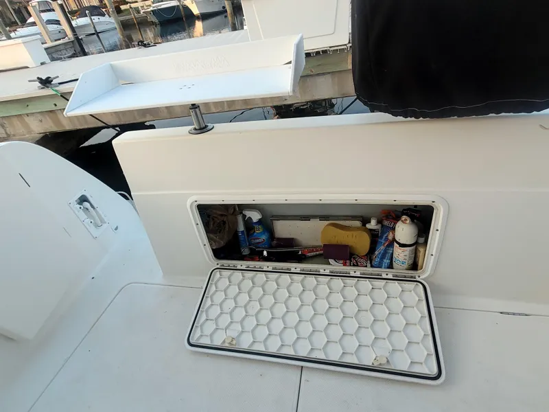 Slide: The Image of Open storage compartment on a 2004 Meridian 341 Sedan boat, containing various maintenance items. - 31