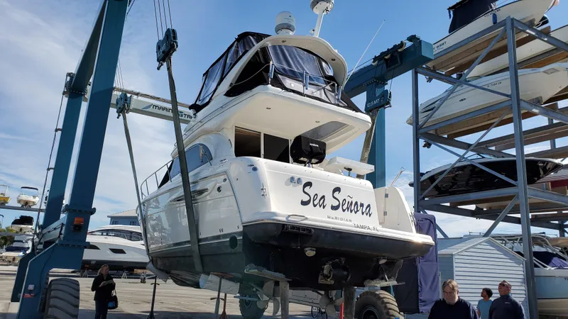 Slide: The Image of 2004 Meridian 341 Sedan yacht on lift at marina, labeled "Sea Señora." - 34