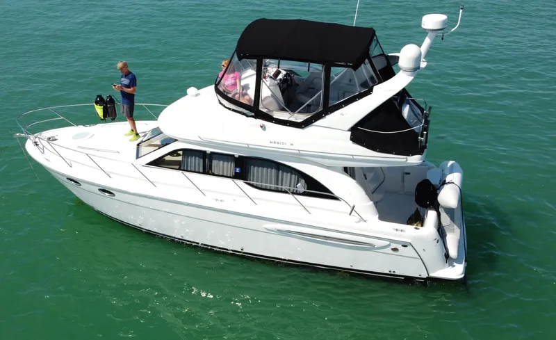 Slide: The Image of 2004 Meridian 341 Sedan yacht cruising on clear turquoise waters. - 35