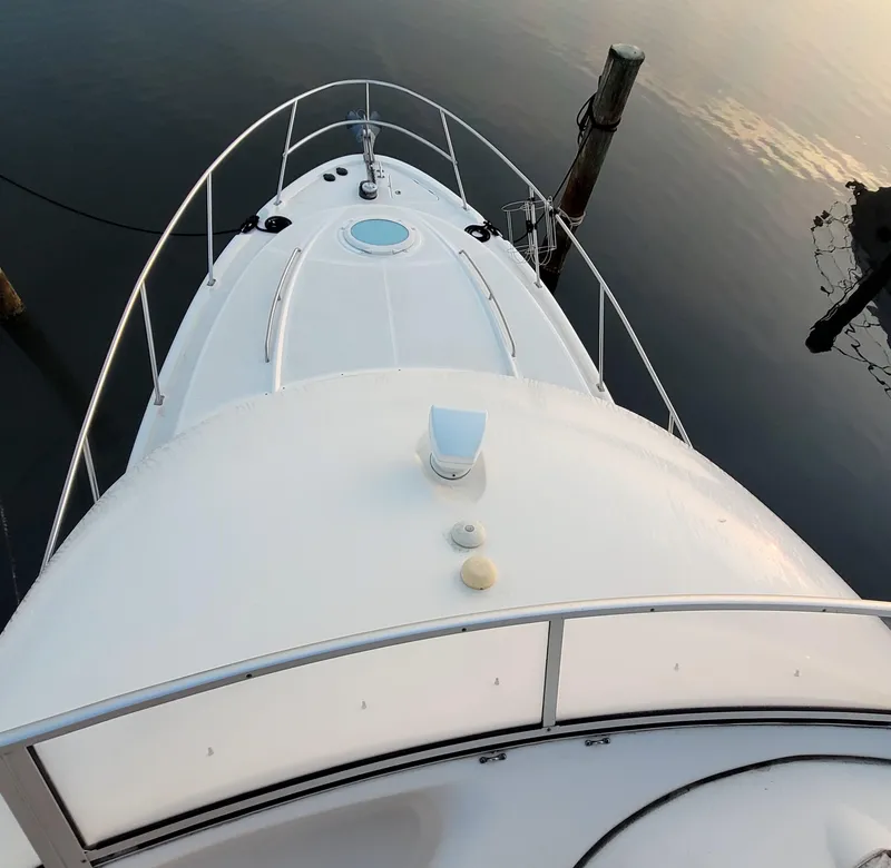 Slide: The Image of 2004 Meridian 341 Sedan yacht bow, docked on calm water. - 7