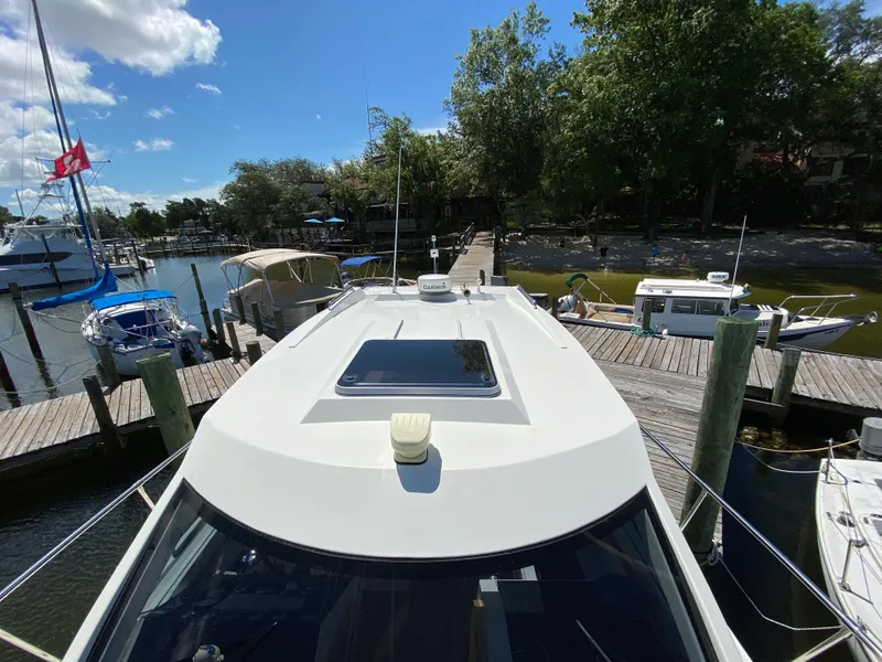 Slide: The Image of Custom Emerald Bay 36 (2018) docked at a marina on a sunny day. - 13