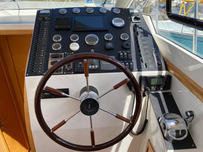 Slide: The Image of Helm of 2018 Custom Emerald Bay 36 yacht with steering wheel and control panel. - 21