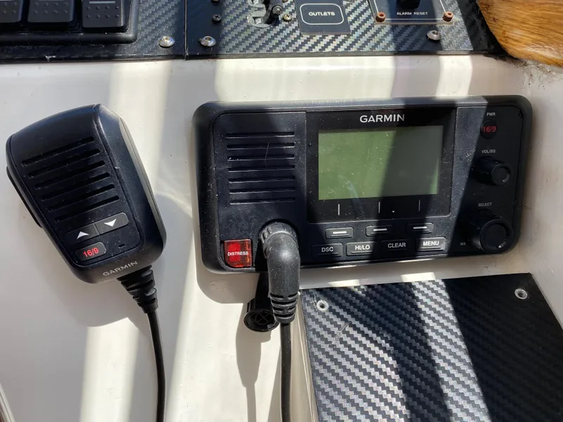 Slide: The Image of Garmin marine radio and microphone on a 2018 Custom Emerald Bay 36 boat. - 23