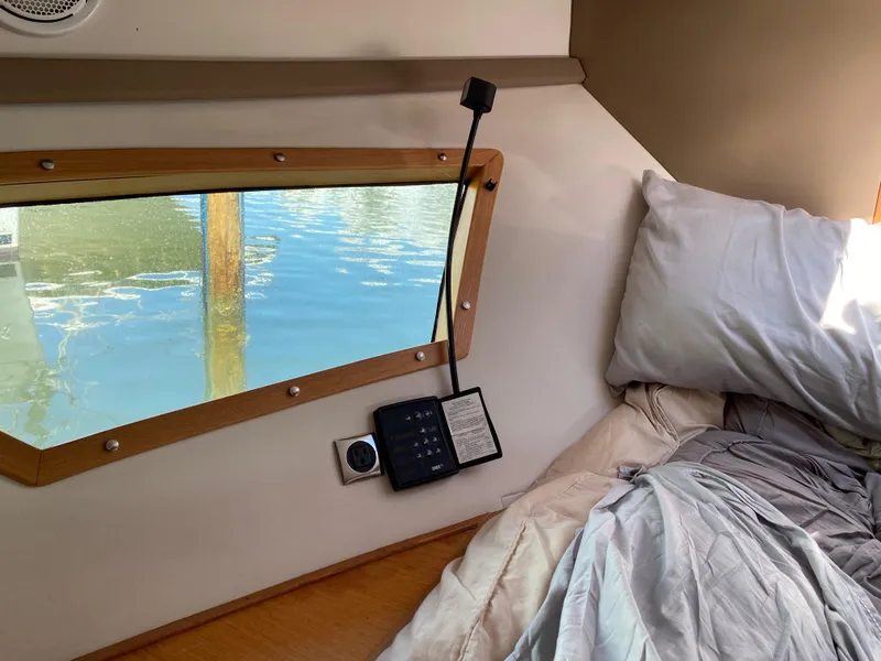 Slide: The Image of Cozy cabin interior of 2018 Custom Emerald Bay 36 boat with window view of water. - 33