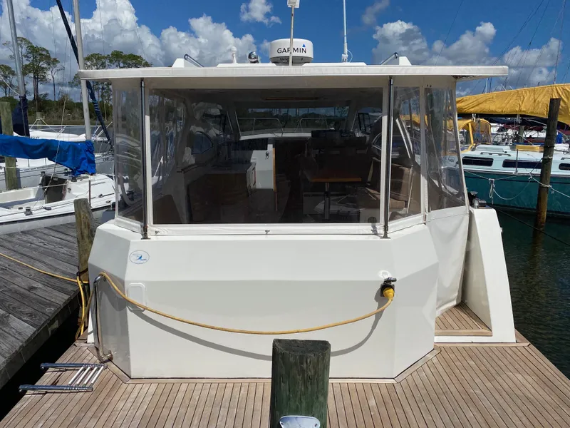 Slide: The Image of Custom Emerald Bay 36, 2018 model, docked at marina with clear skies. - 5