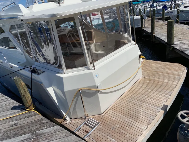 Slide: The Image of Custom Emerald Bay 36 (2018) yacht docked at a marina with wooden deck. - 7