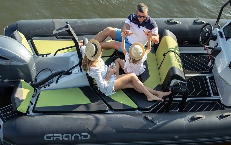 Slide: The Image of Family enjoying a day on a 2024 Grand D600 inflatable boat. - 14